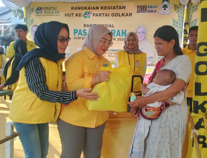
					Dari kiri: Uri Huryati, Ade Puspitasari bersama warga penerima paket sembako murah