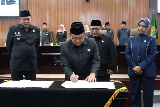 
					Ketua DPRD Kota Bekasi Sardi Efendi menandatangani kesepakatan Perda Penyertaan Modal BUMD.